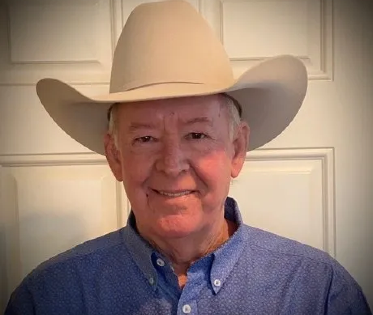 Elderly man with wide-brim hat indoors